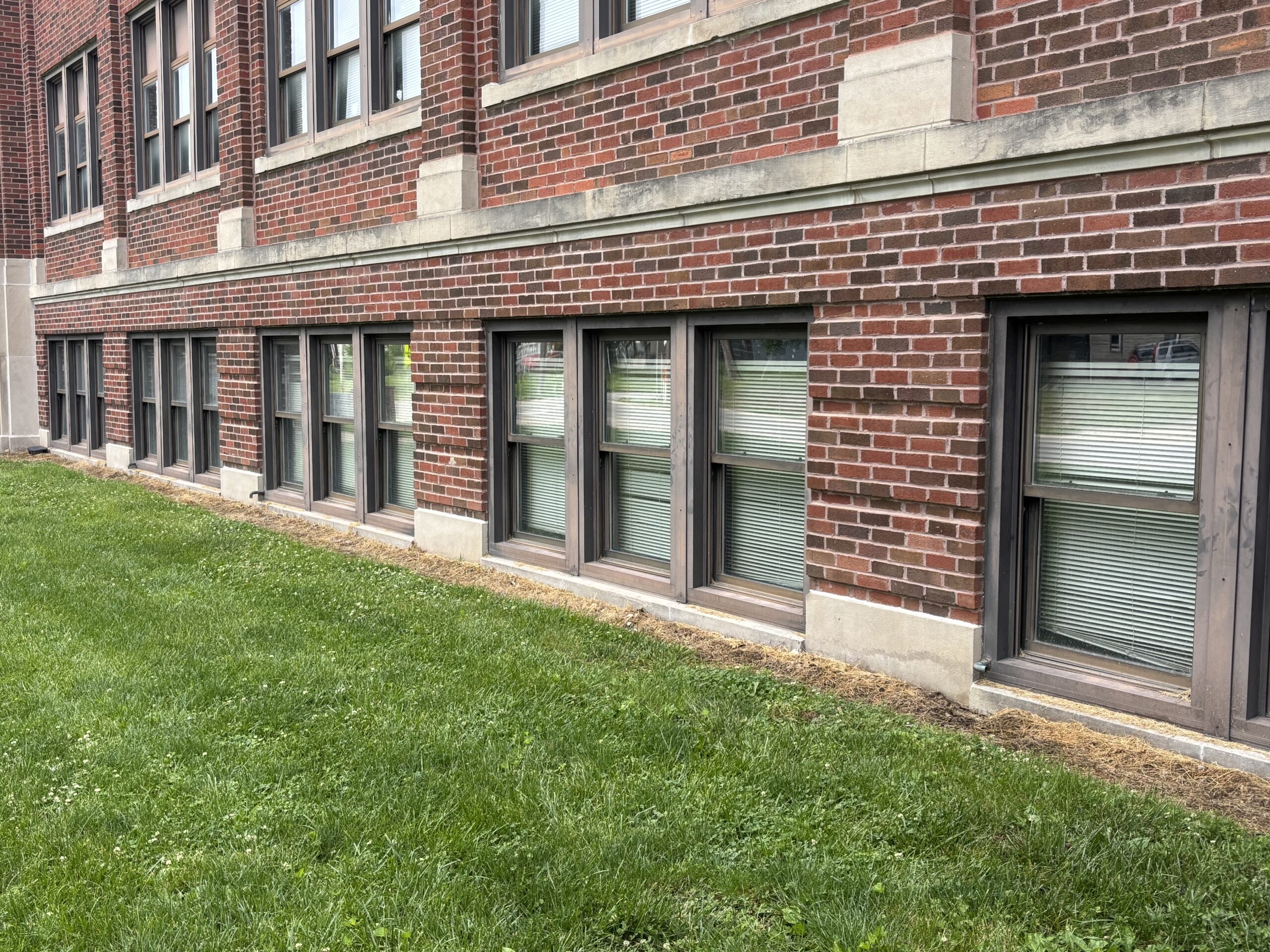 Entry-level classroom window equipped with 16 mil RiotLite security film and additional security attachment