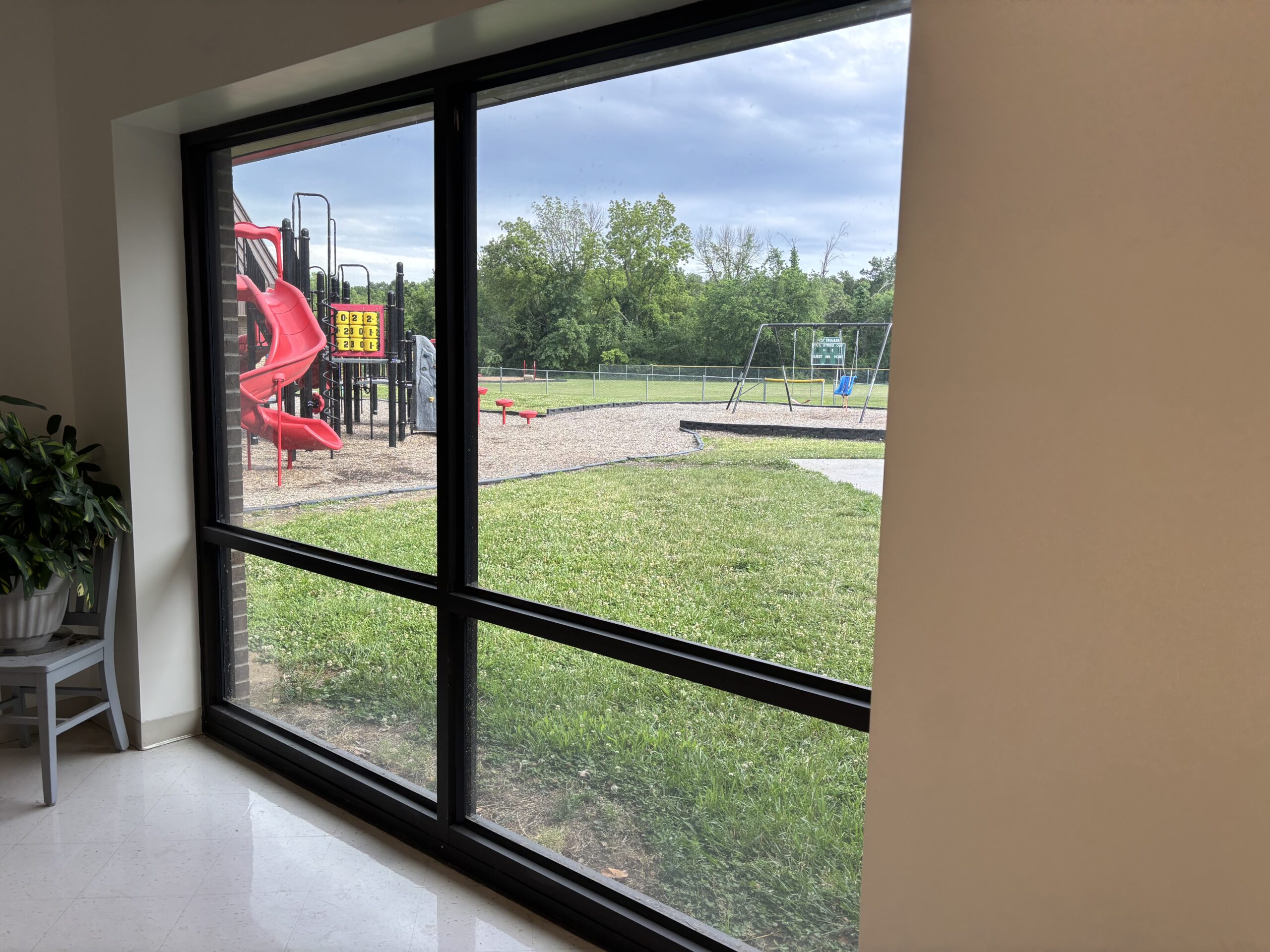 School window installed with 16 mil RiotLite security film and attachment for enhanced protection