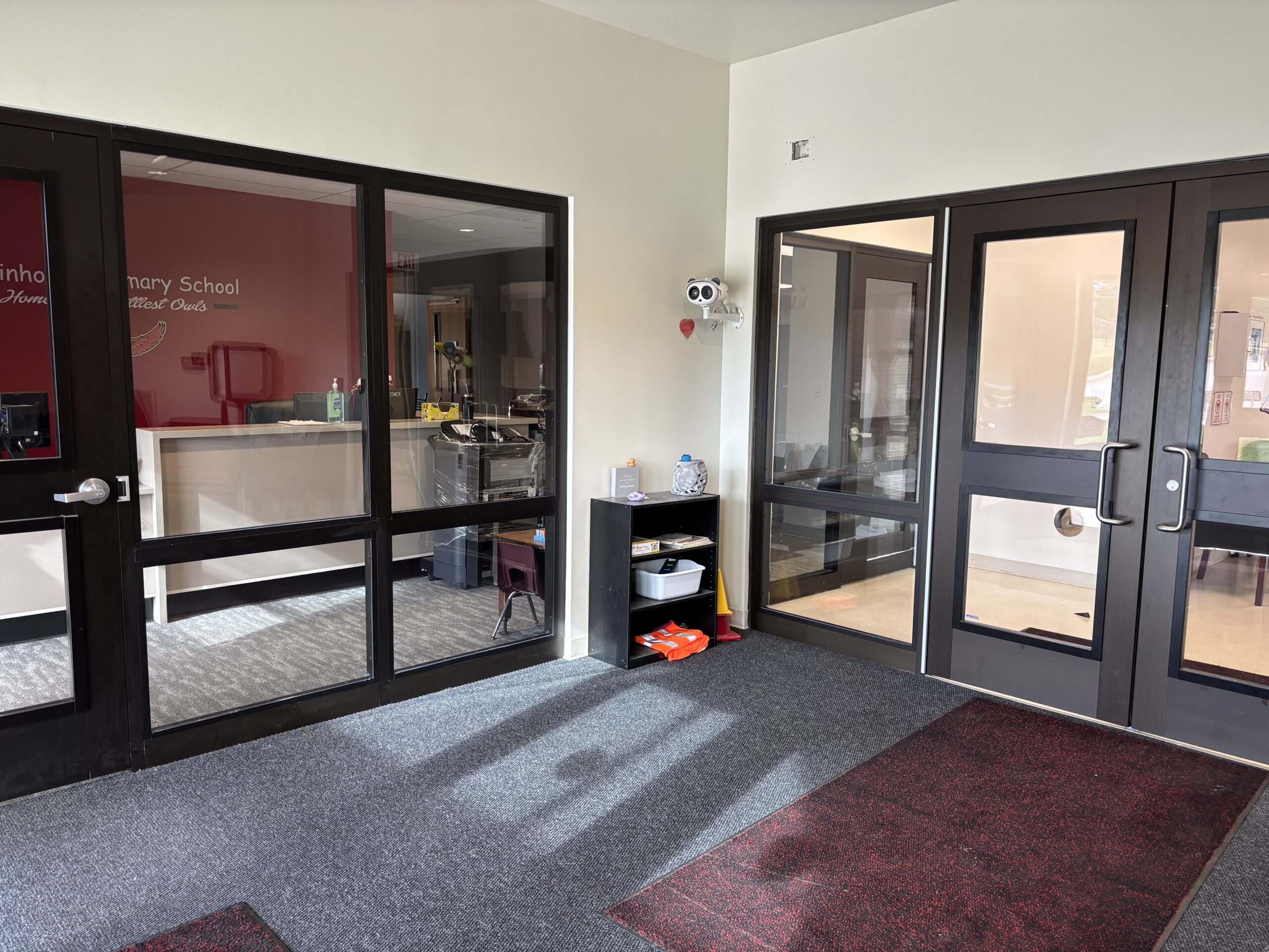Secure vestibule retrofitted with DefenseLite panels for improved security and safety